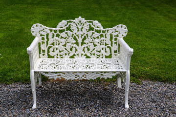 A classic white cast iron two-seater bench with oak leaf design throughout and attractive...