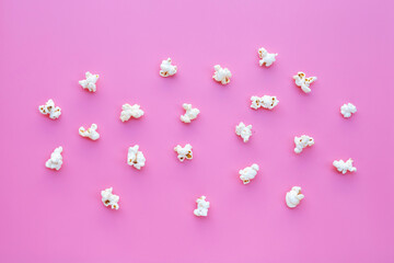 Popcorn on pink background. Copy space