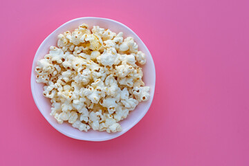 Popcorn on pink background. Copy space