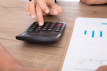 Real estate salespeople use calculators to calculate prices for home buyers