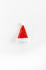 Creative  Santa's hat on white background. Minimal winter flat lay. Christmas concept. New year minimal.
