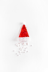 Creative  Santa's hat with snowballs on white background. Minimal winter flat lay. Christmas concept. New year minimal.
