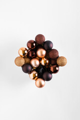 Minimal composition background of plastic brown decorative Christmas balls. New Year concept. Christmas balls on a white background