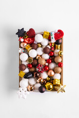 Christmas composition with box full of New Year decoration on a white background. Christmas and New year concept