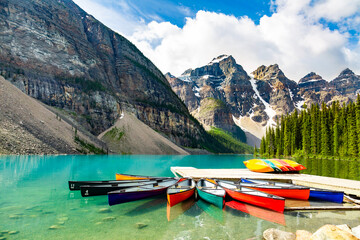 Great view of the famous Moraine Lake, national park in Banff, Canada. Canoeing on the lake in summer. Concept about leisure, sightseeing, travel and nature.  - obrazy, fototapety, plakaty