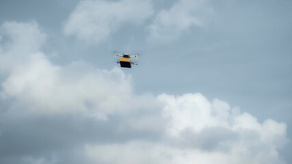 flying on a sky delivery drone with holding a .cardboard parcel