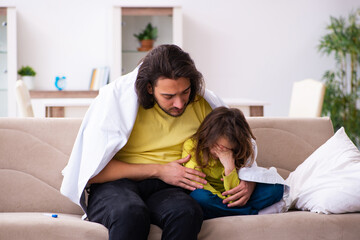 Small girl looking after her sick father