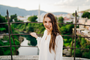 Young woman traveller visiting popular tourist destinations in Southeast Europe,Old Bridge landmark...