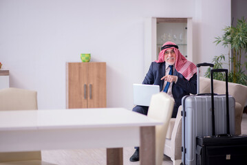 Old arab businessman preparing for business trip