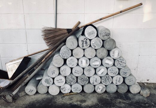 Close-up Of Stacked Concrete Equipment Against Wall