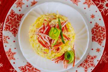 Christmas delicious salad with crab meat, corn, cucumber and eggs.