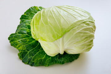 Fototapeta premium Whole green cabbage isolated on a white background.