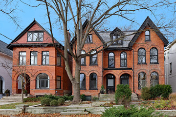 Fototapeta na wymiar Street with large old brick houses with gables