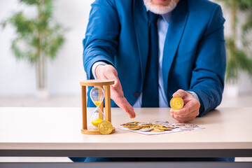 Old man earning money via Internet in time management concept