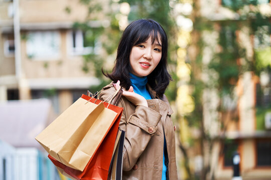 young asian woman returning from a shopping trip