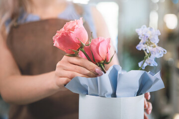 Woman florist collects a bouquet
