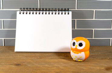Blank note pad with black spiral and orange owl egg timer