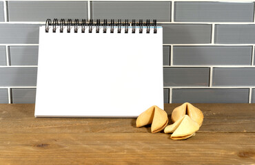 Blank spiral notepad in a modern kitchen with fortune cookies