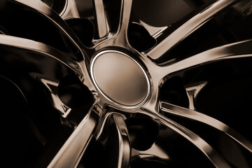 Black Gloss alloy wheel on a dark background. Stylish and expensive. mocap hub cap, reflection