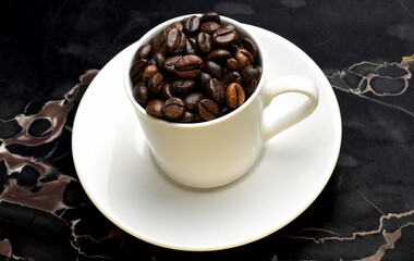 cup of coffee beans on marble 