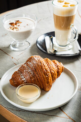 croissant and cappuccino in the cafe