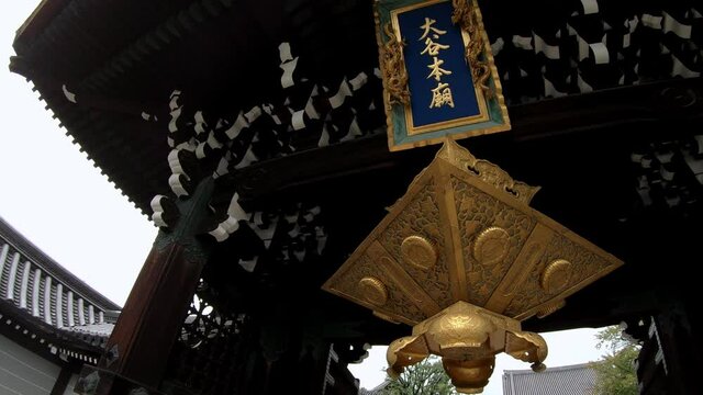 A hexagonal tsuri-doro hanging lantern under the roof of Otani Hombyo mausoleum. Kyoto. Japan