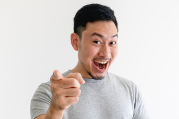 Asian man is pointing into the camera with an excited facial expression.