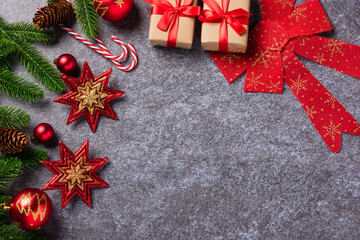 Christmas border decorations holiday, Top view from above green fir tree branches with Xmas ornament baubles, the star on table concrete background, Happy new year concept