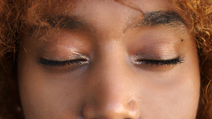 Close up shot of young african american black woman with closed eyes. High quality photo