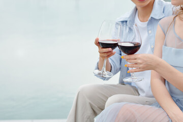 Close-up image of young couple having romantic date and drinking red wine
