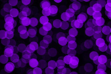 Blurry bokeh background in purple on black.