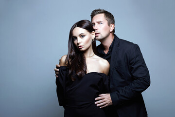 beautiful woman in evening dress in the hands of man in a suit. Young Couple