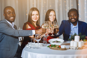 Company of young multinational people at the table.