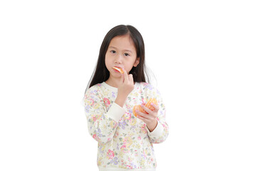 Little asian kid girl eating orange fruit on white background