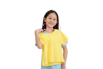 Asian little child girl trying a yellow shirt on white background