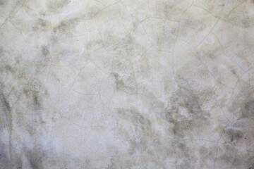 Abstract concrete wall with cracked and scratched surface texture background.