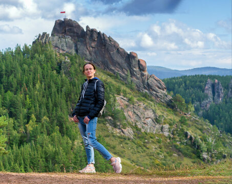 A female is hiking outdoor.