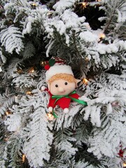 Vintage Elf toy hanging on white Christmas tree