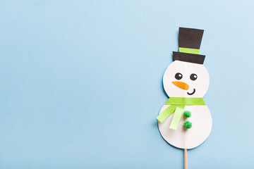 Christmas paper craft for kids. snowman on blue background. create art for children. new year...