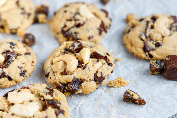 chocolate cookies Fresh organic homemade cookies with chocolate chips and dried berries on parchment paper