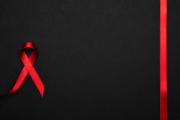 Aids day. Red ribbon symbol in hiv world day on dark background. Awareness aids and cancer....