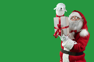 santa claus on a green background holds a box in one hand, the second waves over the days. Christmas magician concept