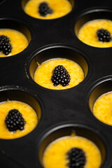 Upside-down berry cupcakes being prepared, food background.
