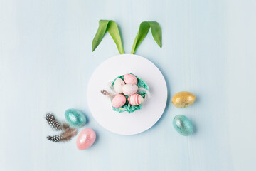 Easter greeting card with colorful easter eggs on blue background. Top view, flat lay with space for your text.