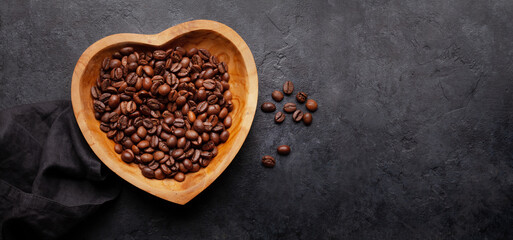 Roasted coffee beans in heart shaped bowl