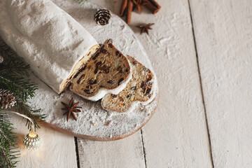 Christmas stollen on wooden background. Traditional Christmas festive pastry dessert. Stollen for Christmas