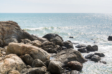 Seascape of waves splashing the stones in the rocky coastline of Yangxi, Yangjiang of China