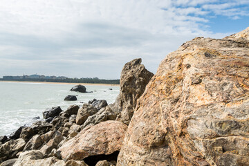 Seascape of waves splashing the stones in the rocky coastline of Yangxi, Yangjiang of China