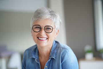 portrait of a beautiful smiling 50-year-old woman with white hair