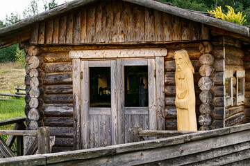 Fototapeta na wymiar A small wooden house made of hewn logs.